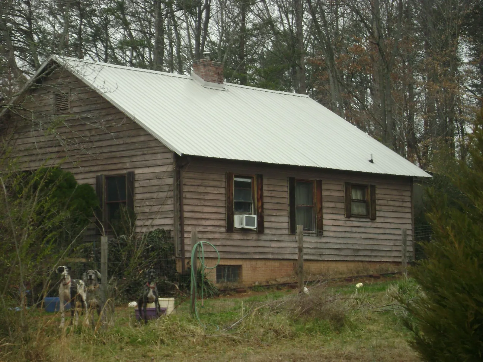 White metal roof on an old wood sided farmhouse, from a Metal Roof Installation job in Stoneham